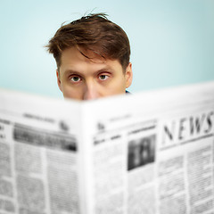 Image showing Man reads news in the newspaper