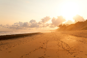 Image showing couple taking a walk on beach in sunset 