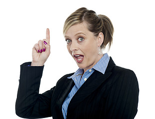 Image showing Shocking corporate woman pointing upwards