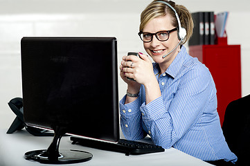 Image showing Aged businesswoman sipping coffee during break