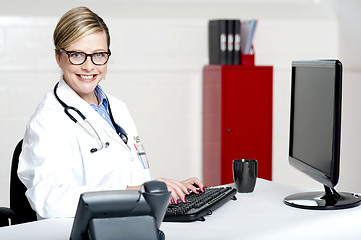 Image showing Female physician using computer