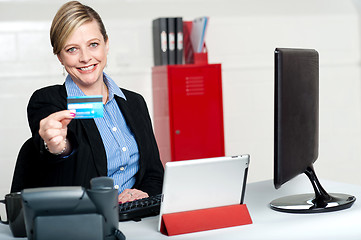 Image showing Beautiful corporate woman holding credit card