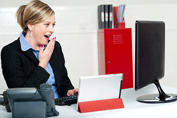 Image showing Surprised female secretary looking at lcd screen