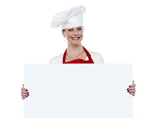 Image showing Matured cook presenting blank billboard