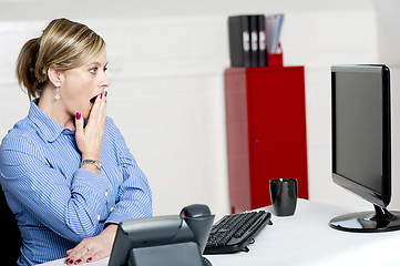 Image showing Shocked businesswoman looking at annual reports