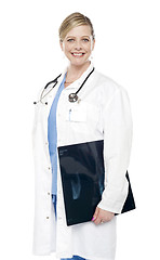 Image showing Smiling female surgeon carrying x-ray report