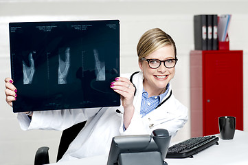 Image showing Medical surgeon expert holding x-ray report