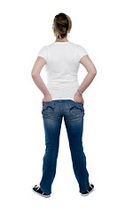 Image showing Back view of trendy woman with hands in pocket