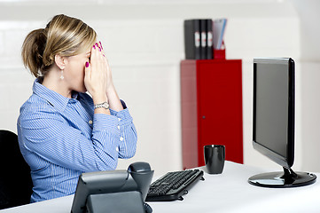 Image showing Female secretary hiding her face with hands