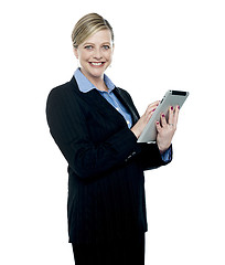 Image showing Smiling corporate woman using wireless tablet pc