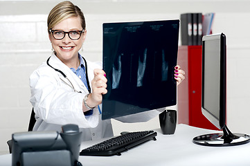 Image showing Experienced female physician holding x-ray