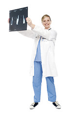 Image showing Cheerful female doctor holding x-ray report