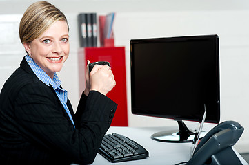 Image showing Corporate lady enjoying coffee during break