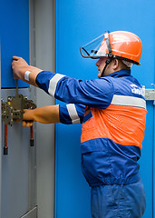 Image showing caucasian electrician working on a panel
