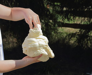 Image showing making dough outdoors