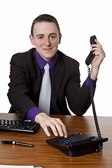 Image showing  Businessman dialing telephone number