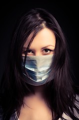 Image showing Young woman in a protective mask