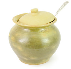 Image showing Old ceramic pot with a spoon