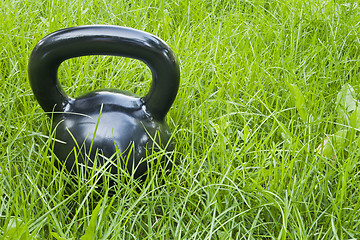 Image showing heavy iron  kettlebell in grass