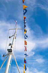 Image showing Mast with the navigating equipment of a yacht and alarm flags