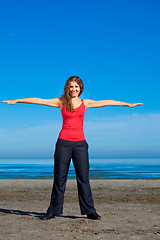 Image showing girl doing morning exercises at the beach