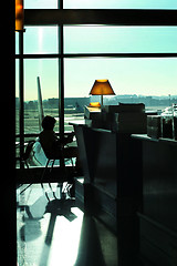 Image showing Woman reading at the airport