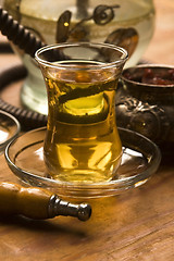 Image showing Cup of turkish tea and hookah served in traditional style