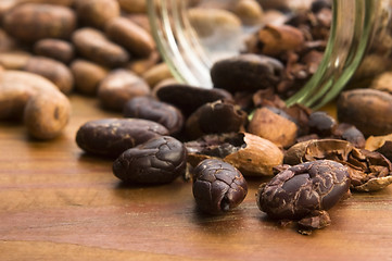 Image showing Cocoa (cacao) beans on natural wooden table