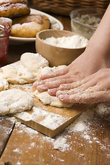 Image showing Detail of hands kneading dough