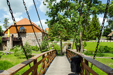 Image showing Rusty chains hold bridge in park 