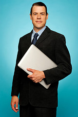 Image showing Businessperson carrying a laptop