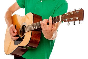 Image showing Cropped image of a man playing guitar