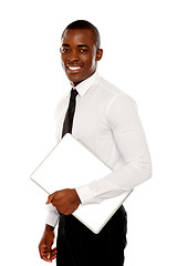 Image showing African businessman carrying laptop