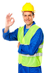Image showing Handsome young worker gesturing okay sign