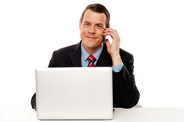 Image showing Businessman working and talking on cell phone