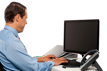 Image showing Side view male accountant working in office