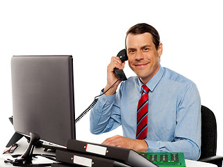 Image showing Businessman talking on phone, handling clients