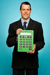 Image showing Corporate guy showing big green calculator