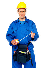 Image showing Smiling male worker wearing yellow safety hat