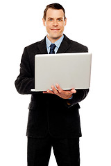 Image showing Confident executive using laptop and surfing web