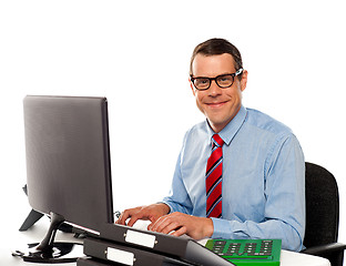 Image showing Happy young corporate man using computer