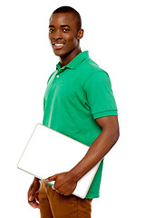 Image showing Casual teenager carrying laptop