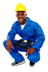Image showing Seated african worker posing with a smile
