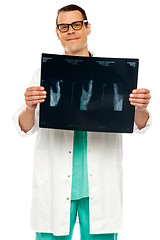 Image showing Handsome young surgeon holding x-ray