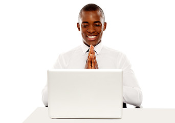 Image showing Cheerful manager looking at laptop screen