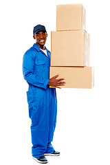 Image showing Young delivery boy holding cardboard boxes