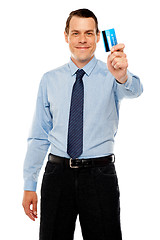 Image showing Smiling executive showing credit card