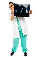 Image showing Young surgeon showing x-ray report of patient