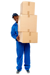 Image showing Delivery boy carrying heavy boxes