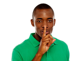 Image showing Young african guy showing silence gesture